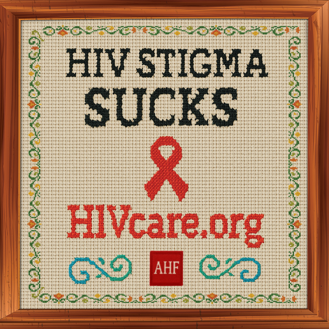 A framed cross-stitch design reads “HIV STIGMA SUCKS” with a red ribbon, HIVcare.org, and the AHF logo, bordered by floral embroidery.